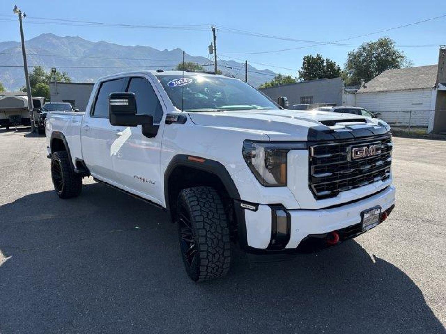 2024 Summit White /Jet Black with Kalahari accents GMC Sierra 3500HD (1GT49VEY8RF) with an 8 6.6L engine, Automatic transmission, located at 3240 Washington Blvd., Ogden, 84401, (801) 621-7177, 41.204967, -111.969994 - *2024 GMC Sierra 3500HD AT4*Loaded! Two-tone leather (heated and cooled) power seats, sunroof, power running boards, remote start, multi-function tailgate, 360 backup camera, Rev Industries hard folding bed cover, heads-up display, wireless phone charger, 22 Fuel wheels with Toyo Open Country A/T II - Photo#2